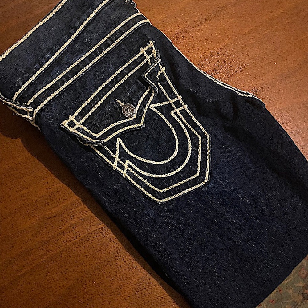 Dark blue denim true religion jeans.
